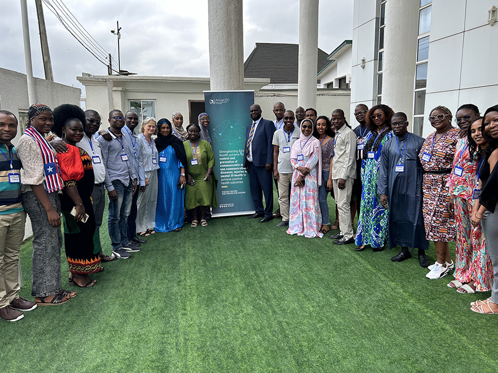 Africa CDC Gathering around banner