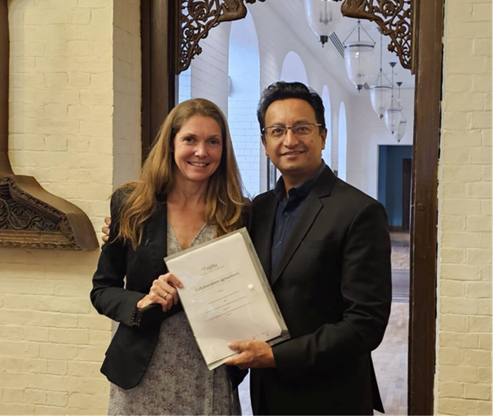 Picture of two persons holding a collaboration agreement.